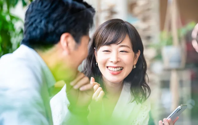 笑顔で会話するミドル男女